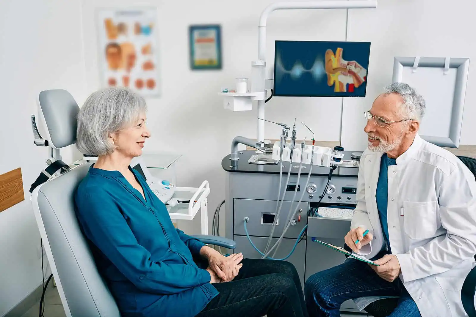Audiologist asking patient questions for hearing evaluation